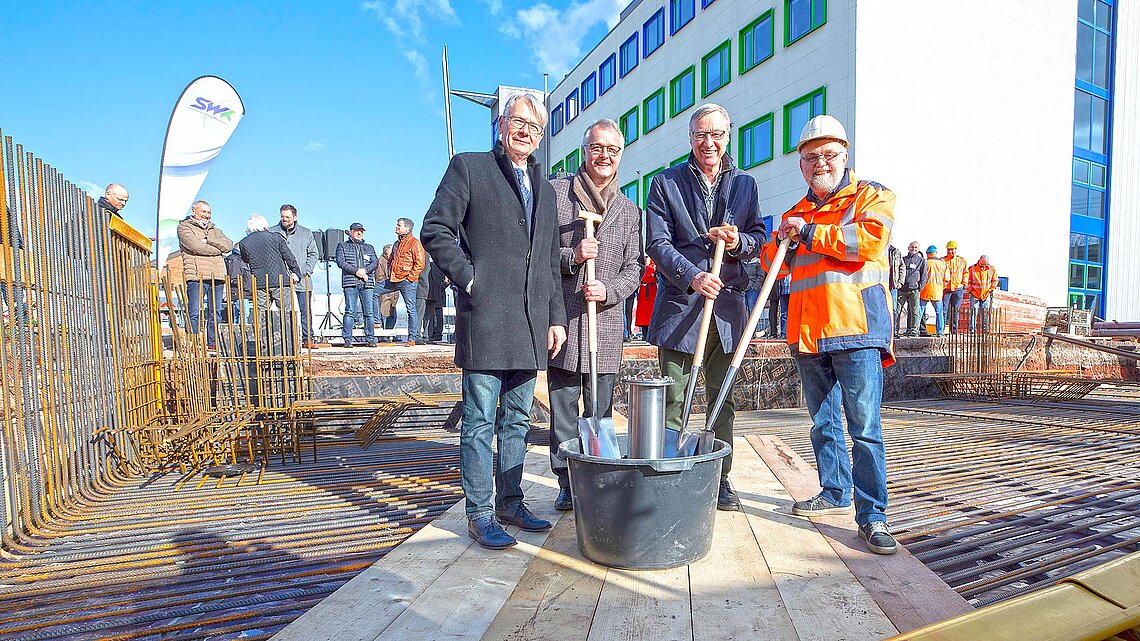 Personen an Baustelle mit Schaufeln in Hand SWK-Event